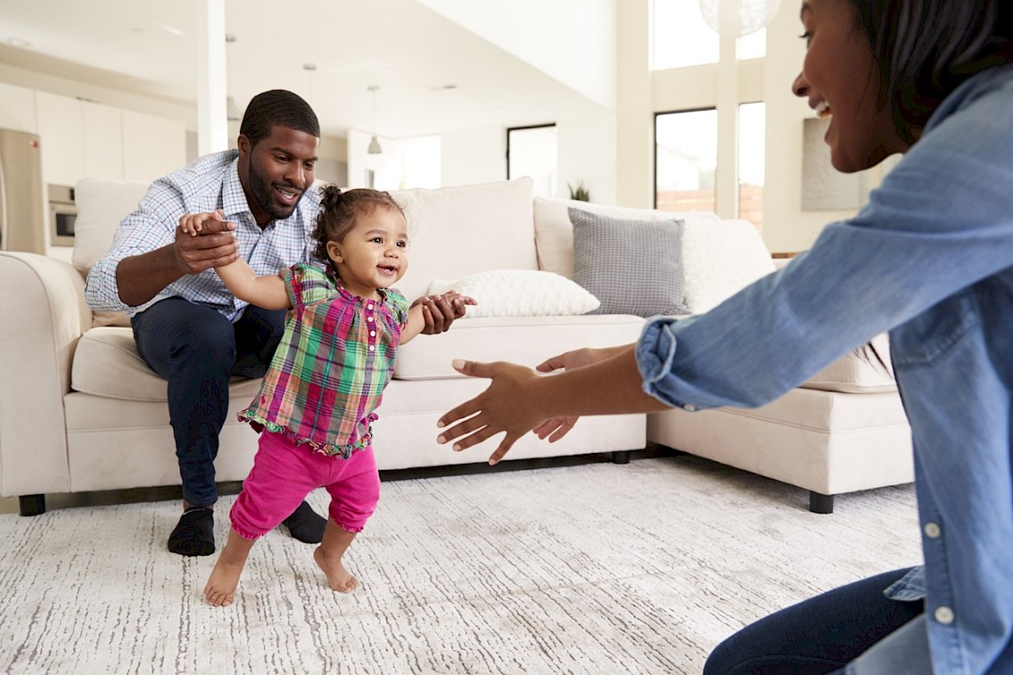 Child running into arms of parent